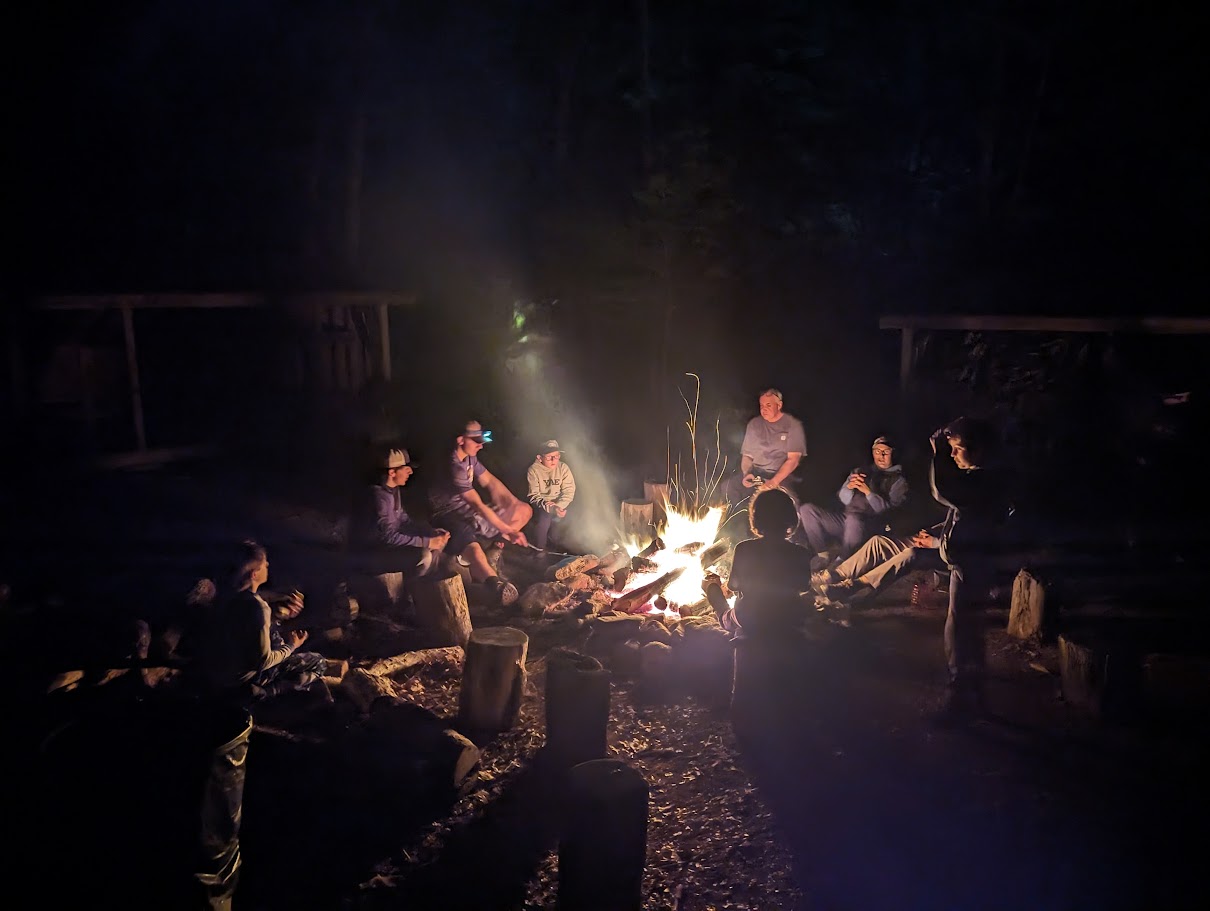 Scouts gathered around a campfire at Deer Lake.